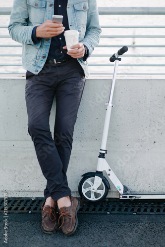 Hipster man with scooter and phone