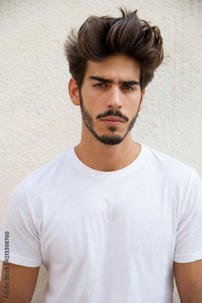 Portrait of a handsome young man with goatee looking at camera Portrait of a handsome young man with goatee looking at camera