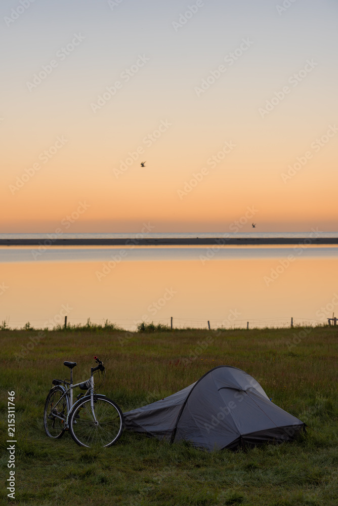 Naklejka premium Touristic camp with bicycle and sunrise in summer ,Iceland.