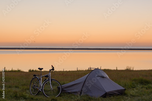 Touristic camp with bicycle and sunrise in summer ,Iceland.