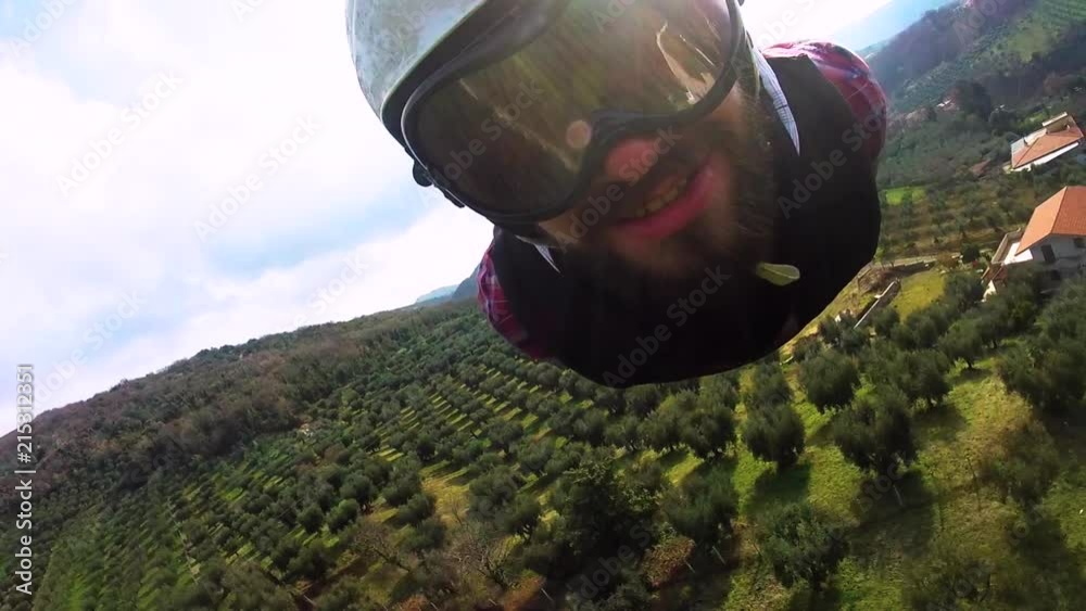 Young man riding a zip line. Extreme Attraction for Tourists ziplines, the largest in Europe. Extreme sports. Male Enjoying Zip Line Tour in Italy.