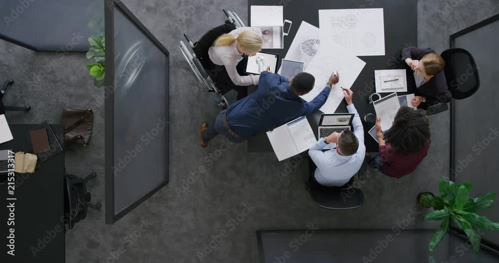 young multi ethnic business team engineers designing wind turbine brainstorming ideas working on design schematics solution in office innovation engineering top view