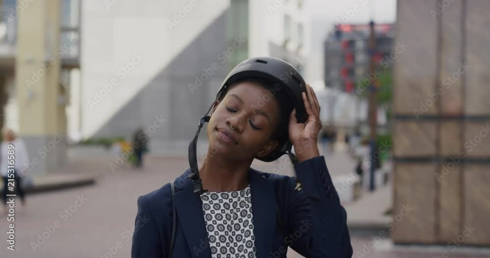 portrait beautiful black business woman takes off helmet confident black female commuter enjoying urban travel lifestyle in city slow motion portrait beautiful black business woman takes off helmet confident black female commuter enjoying urban travel lifestyle in city slow motion