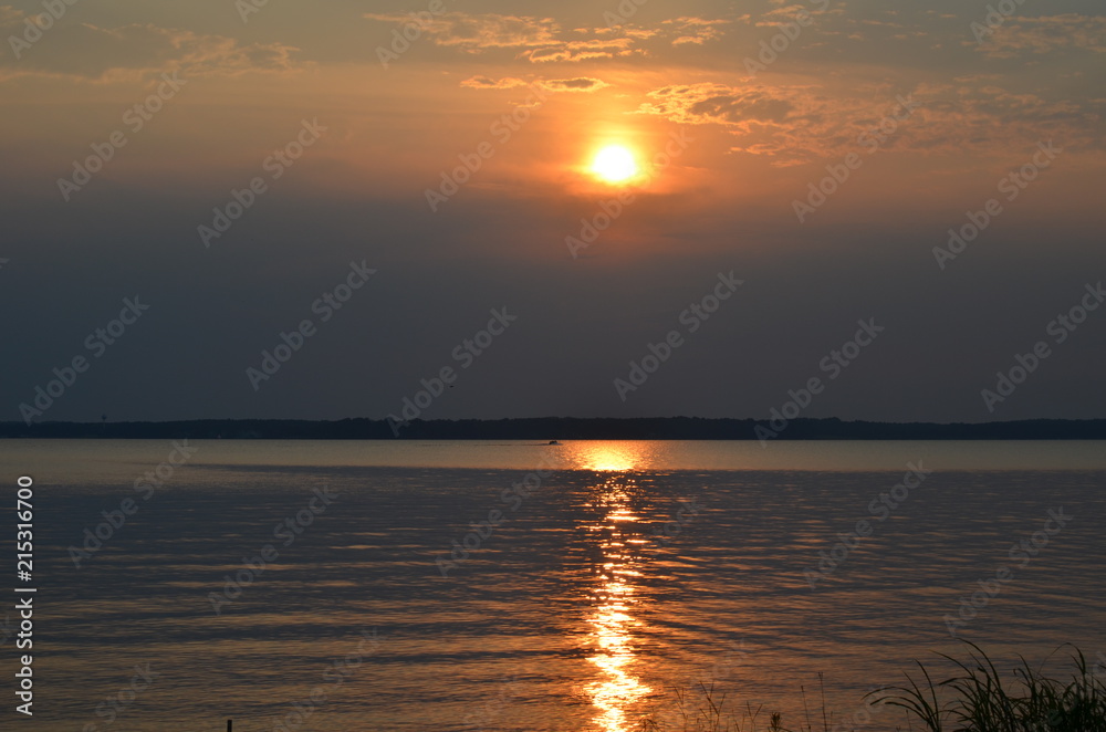 reflection of a sunset off a lake