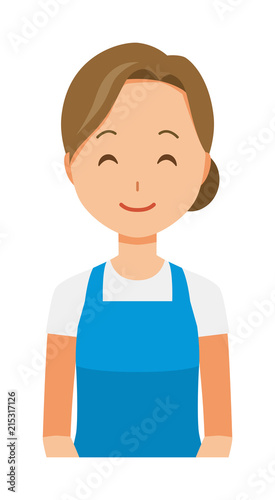 A woman wearing a blue apron is smiling