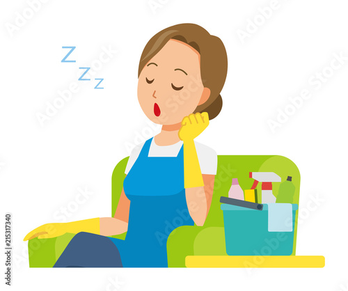 A woman wearing a blue apron and rubber gloves is falling asleep sitting on the sofa