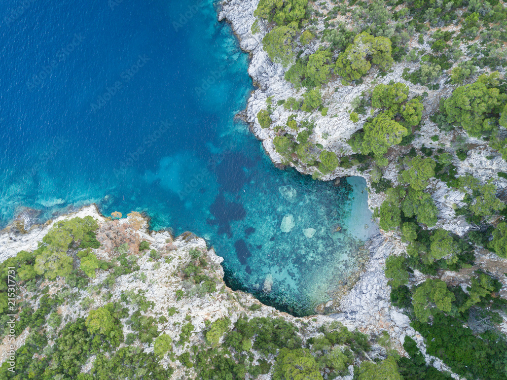 View from above of a cove formed with private and secluded beach on the island of Skopelos in Greece.