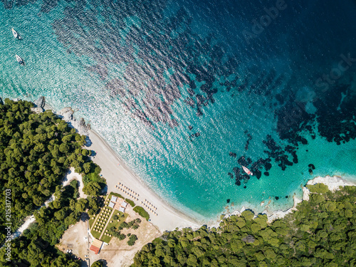 Early morning sunrise on the private beach on the island of Skopelos in Greece. Perfect aqua water and coral for diving and snorkelling at Kastani Beach