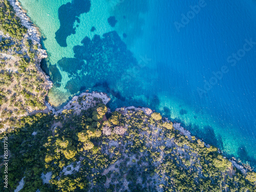 Island coastline of Skopelos in Greece with a little cave coming in from the ocean.