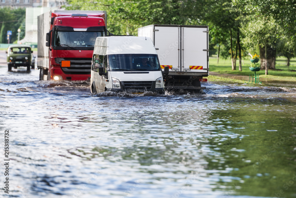 City traffic along the flooded city street.
