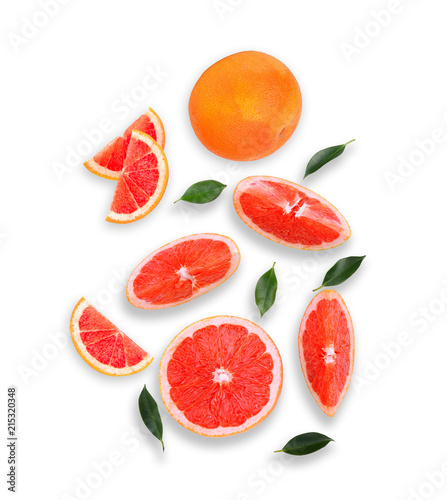 whole and slices grapefruit with green leaves isolated on white background, flat lay, top view