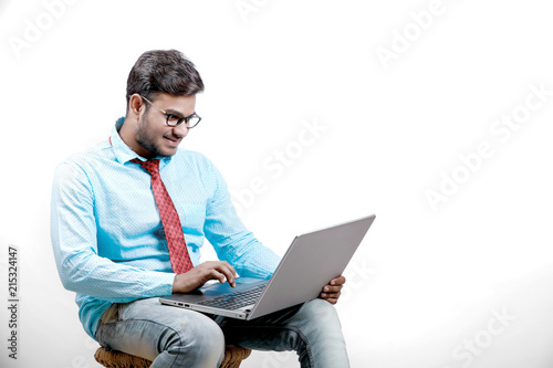Young indian male using laptop