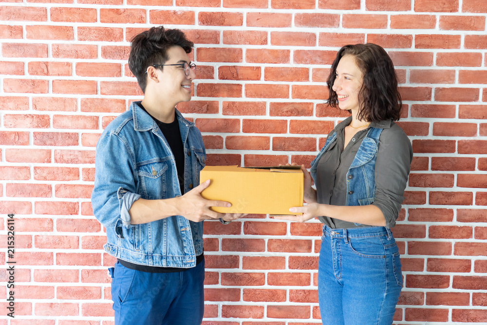  Woman accepting a delivery brown boxes from deliveryman