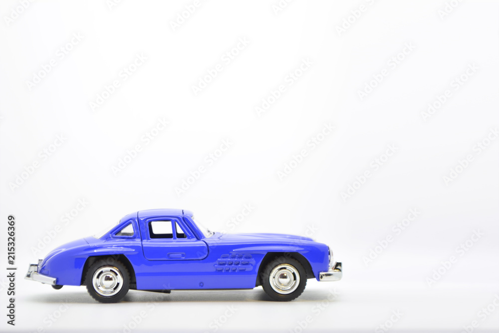 Little ancient model toy car isolated on background. Little ancient model toy car isolated on background.