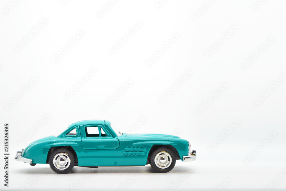 Little ancient model toy car isolated on background.