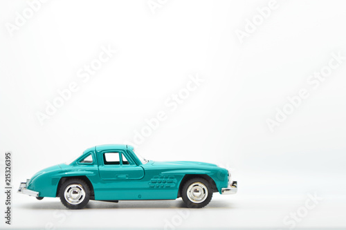 Little ancient model toy car isolated on background.