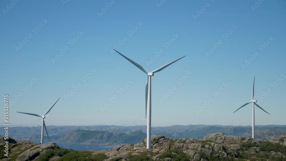 Tree windmills with mountains and windmill in the background. Tree windmills with mountains and windmill in the background.