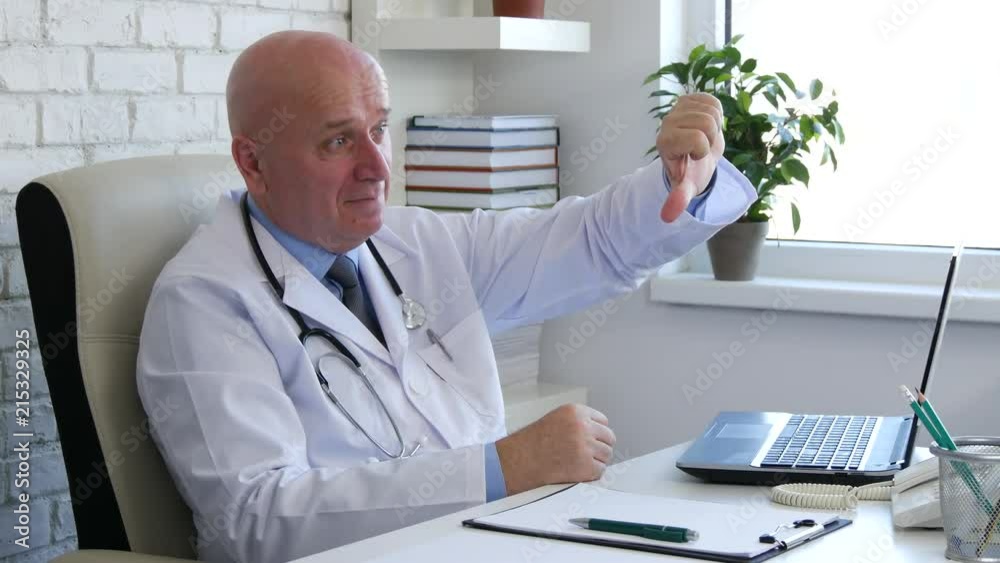 Doctor Image Smiling and Making a Dislike Hand Gestures Doctor Image Smiling and Making a Dislike Hand Gestures