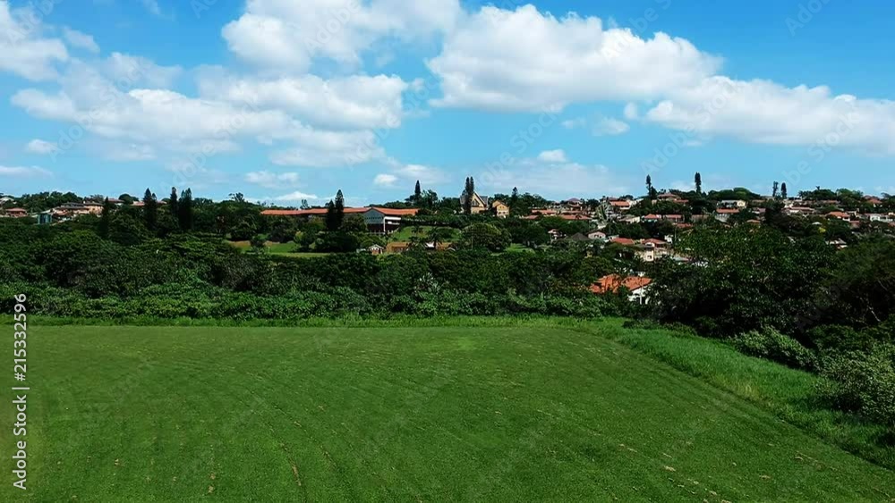 Aerial clip of some green agriculture fields near a town. Aerial clip of some green agriculture fields near a town.