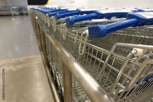 Bunch of empty blue shopping cart at supermarket entrance, trolleys car supermarket use in case customer have a lot of products