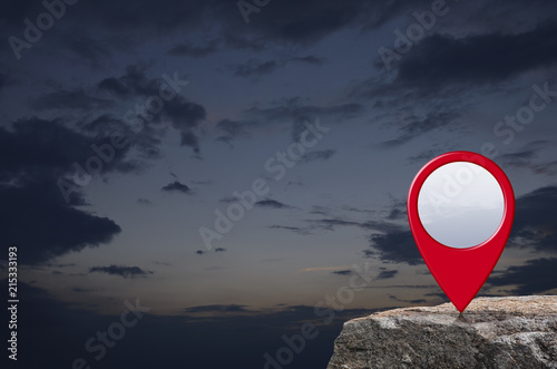 Map pin point location button on rock mountain over sunset sky, Map pointer navigation concept