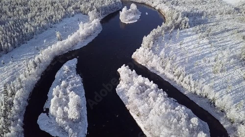 Flying above river in Lapland when first snow has just fallen to ground. Lapland Finland. photo