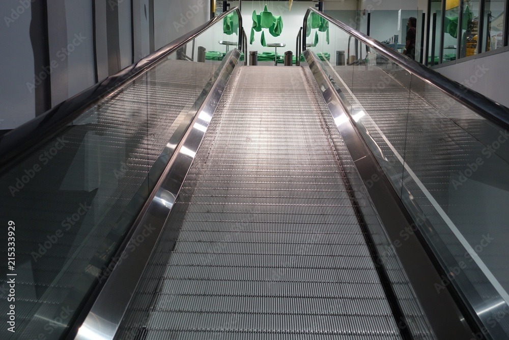 Closeup of escalator in department store for customer use in case they have a lot of products Closeup of escalator in department store for customer use in case they have a lot of products