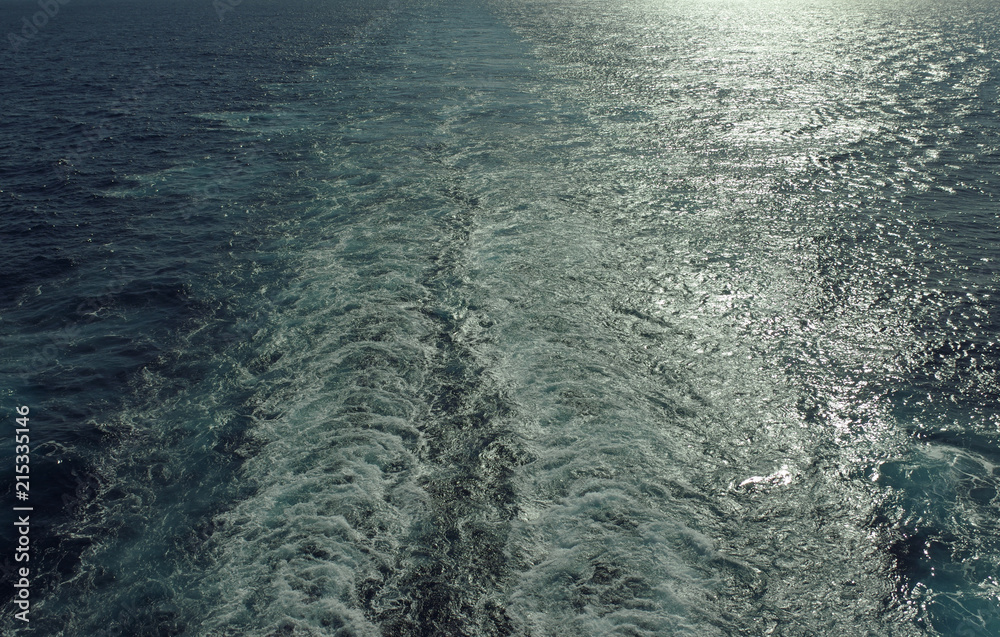 Wake of a cruise ship against the light