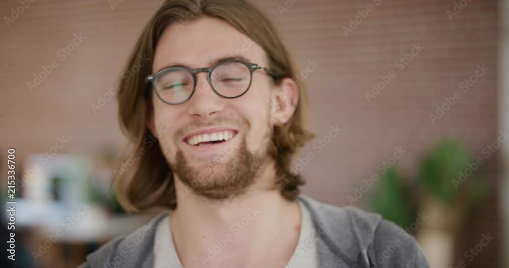 close up portrait of handsome young man laughing happy enjoying success geek wearing glasses looking at camera real people series close up portrait of handsome young man laughing happy enjoying success geek wearing glasses looking at camera real people series
