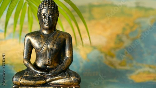 World Map. Journey Explore Concept. Abstract travel destination background with copy space. Trip Southeast Asia. Sitting buddha as symbol of asian culture. Close up slill life, soft selective focus. photo