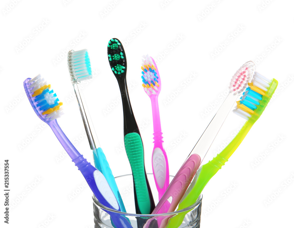 Cup with different toothbrushes on white background. Dental care Cup with different toothbrushes on white background. Dental care