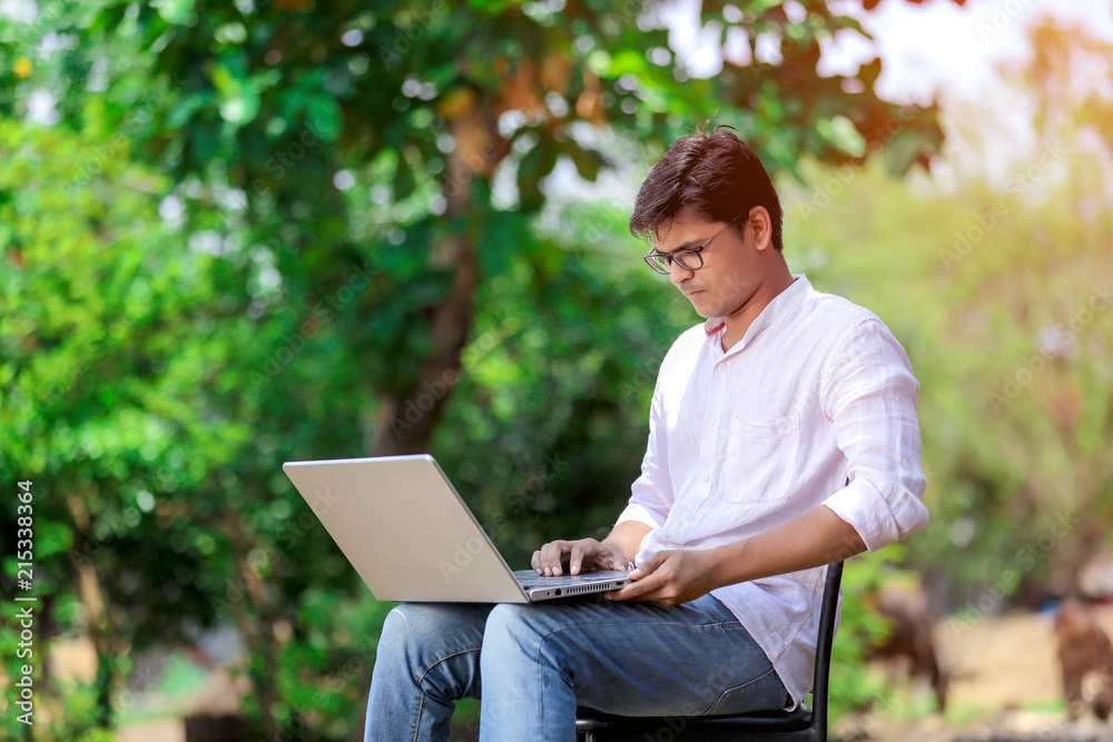 young Indian man using laptop , Working on Laptop young Indian man using laptop , Working on Laptop