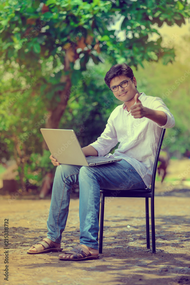 young Indian man using laptop , Working on Laptop young Indian man using laptop , Working on Laptop