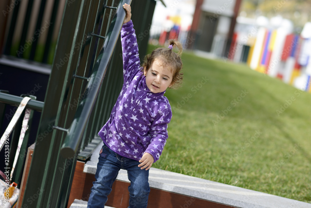 Little girl going down some stairs outdoors Little girl going down some stairs outdoors