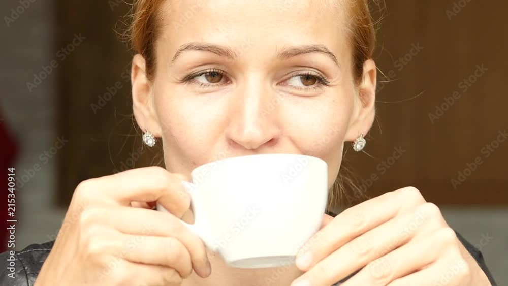 Pretty woman have a lunch on summer terrace, close-up girl drinks coffee or tea. slow motion Pretty woman have a lunch on summer terrace, close-up girl drinks coffee or tea. slow motion