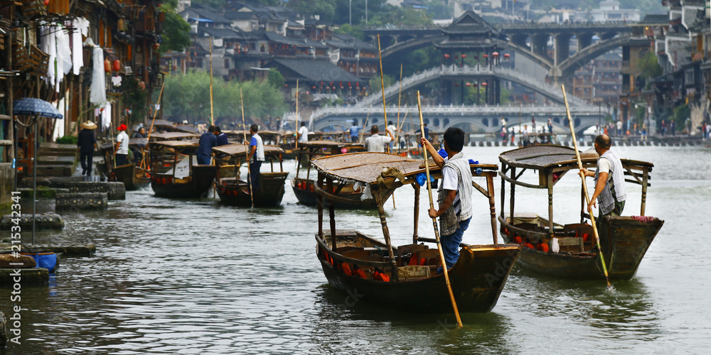 Boat man on the river in fenghuang old city,China