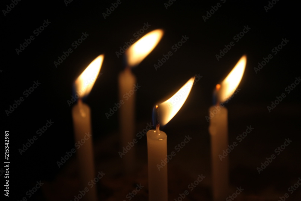 candles burning brightly on black background candles burning brightly on black background