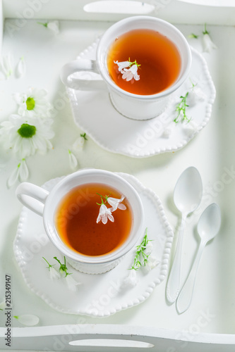 To cup of tea with honey on white background