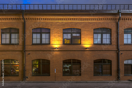 Evening in the old quarter. Office building in loft style. Brick building with large Windows.