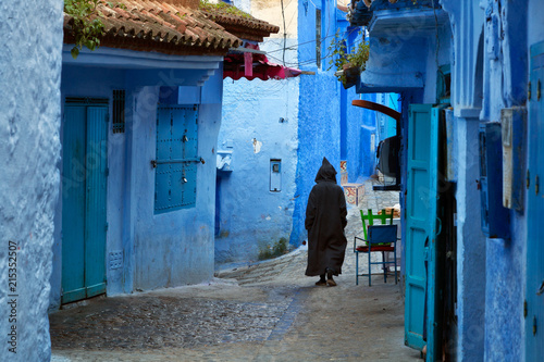 Man walking in the blue medina of Chefchaouen, Morocco © spumador