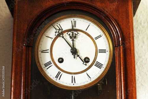 Dial of antique wooden clock from close-up.