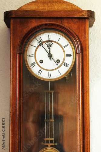 Antique wooden clock with pendulum. 