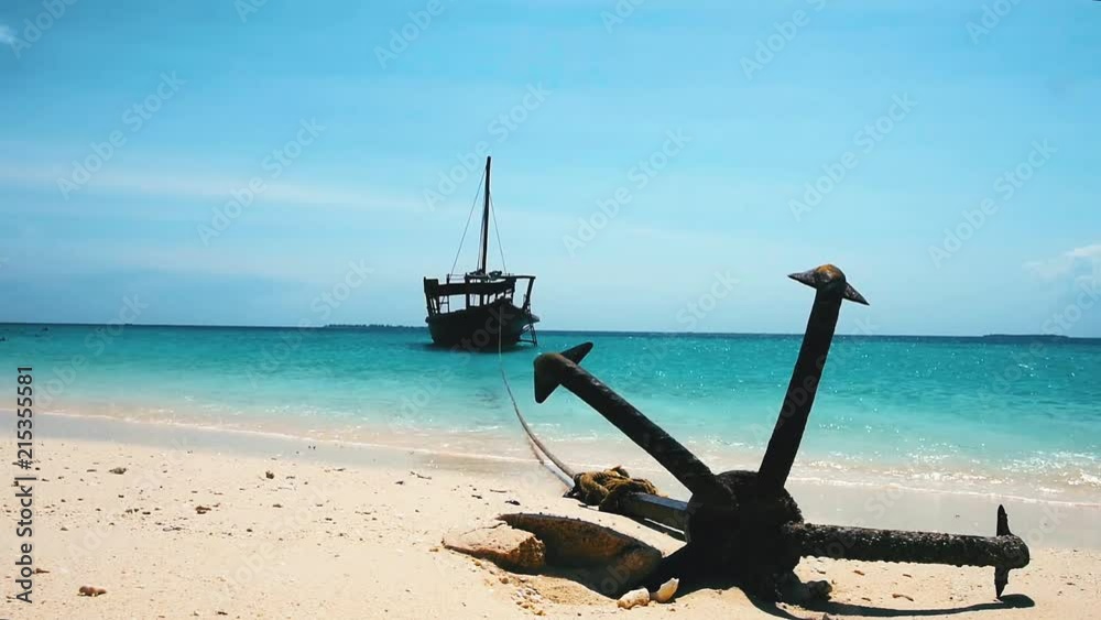 Anchor holds the boat in shallow water under blue sky on the coast of the Zanzibar island Anchor holds the boat in shallow water under blue sky on the coast of the Zanzibar island