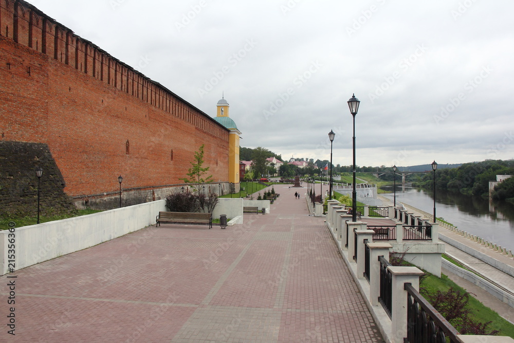 Russia, Smolensk - central park, Kremlin, view from the bridge to the Smolensk fortress wall and concrete embankment of the Dnieper river in the summer cloudy day