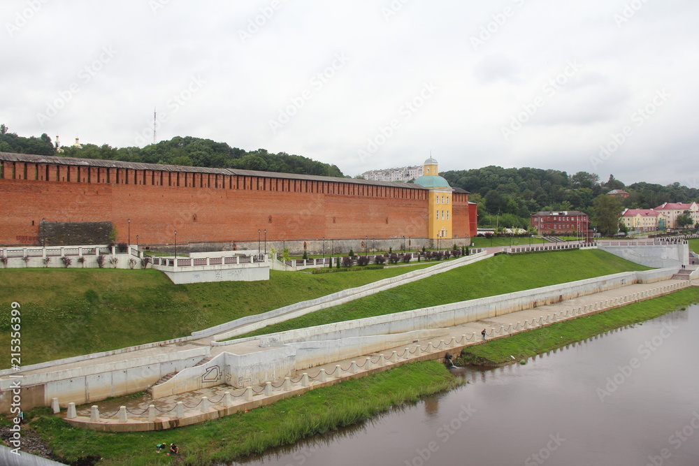 Russia, Smolensk - view from the bridge to the Smolensk fortress wall and concrete embankment of the Dnieper river in the summer cloudy day