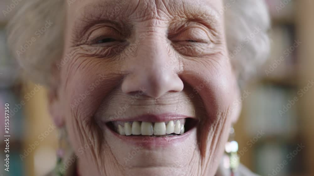 close up portrait of cheerful elderly woman smiling happy looking at camera enjoying retirement