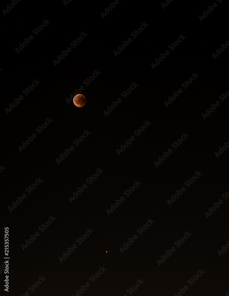 Bloody moon in the dark sky 2018. Crimson moon. Mars below