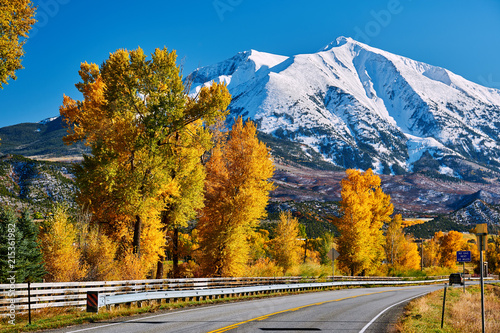 Highway in Colorado Rocky Mountains at autumn photo