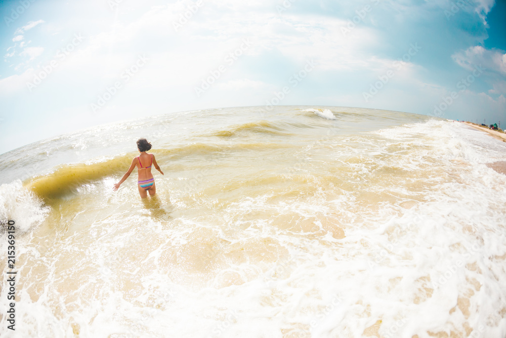 Woman bathing in the ocean.