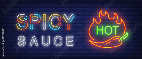 Spicy sauce, hot neon text with chili pepper and fire flames. Cafe or restaurant advertisement design. Night bright neon sign, colorful billboard, light banner. Vector illustration in neon style.